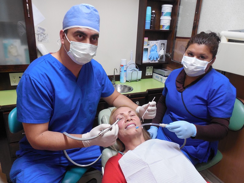 Dr. Jimenez and a dental team member treating a patient