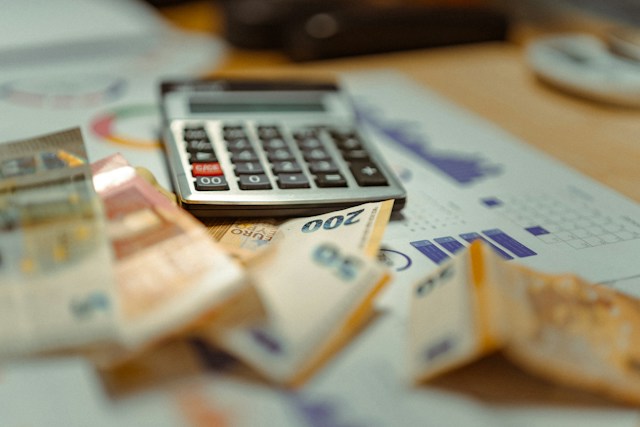 Calculator and euro notes representing treatment cost planning