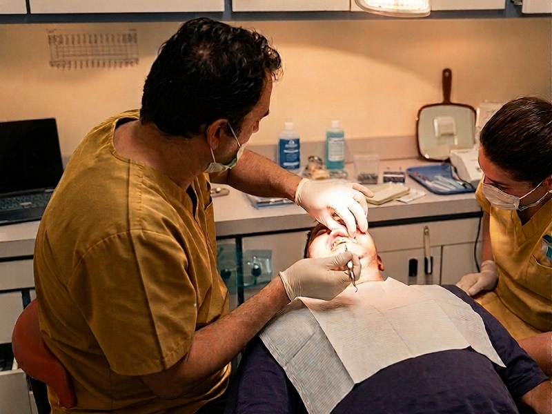 Dr. Jimenez and a dental team member treating a patient