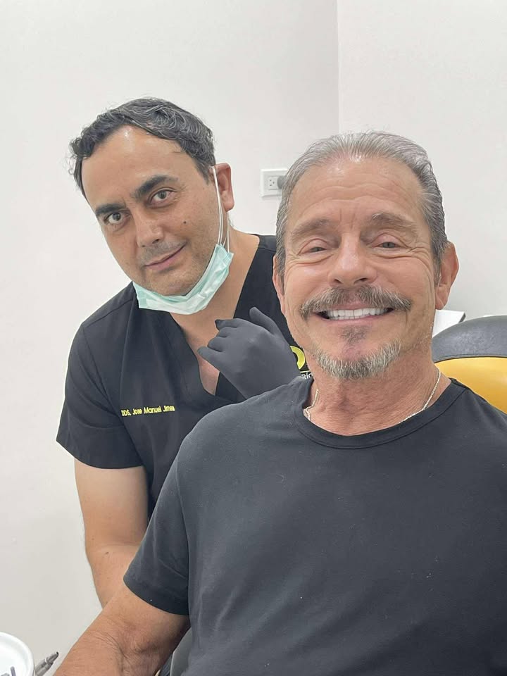 A patient smiling with his dentist