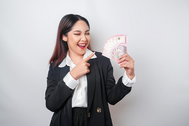 Woman smiling while holding money